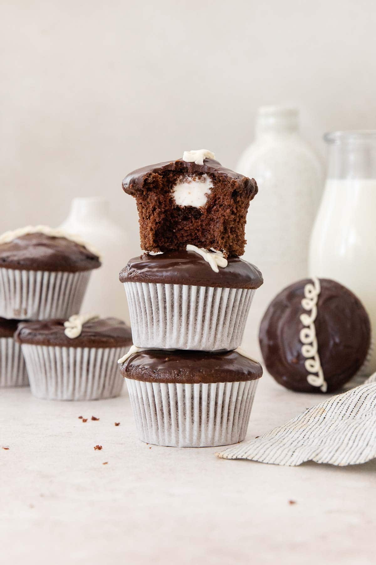Gluten-free Hostess cupcakes stacked on top of each other on a countertop.