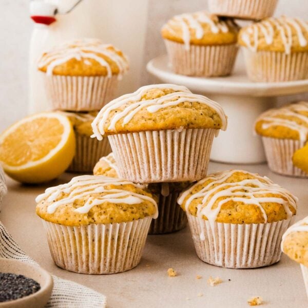 a lemon poppy seed muffin stacked on top of three other lemon poppy seed muffins.