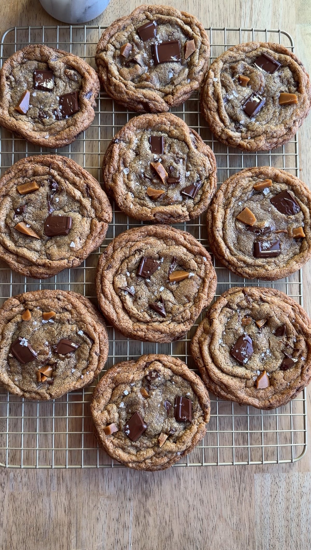 brown butter toffee chocolate chip cookies on a wire rack.